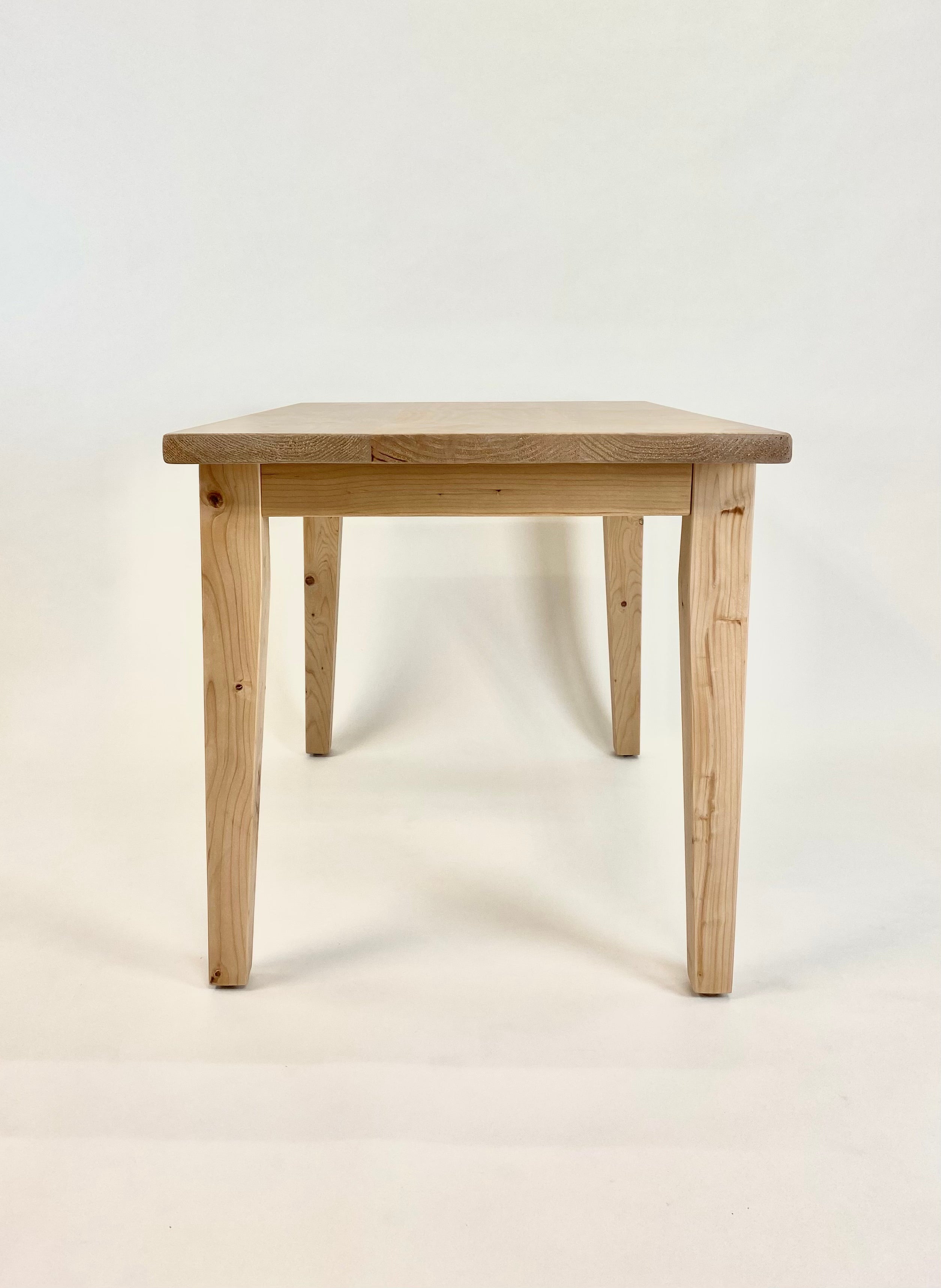French farmhouse kitchen table handcrafted from reclaimed wood end view