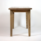 A counter hight wooden kitchen island with a natural finish, featuring four straight legs and a simple rectangular top, photographed against a plain white studio background.