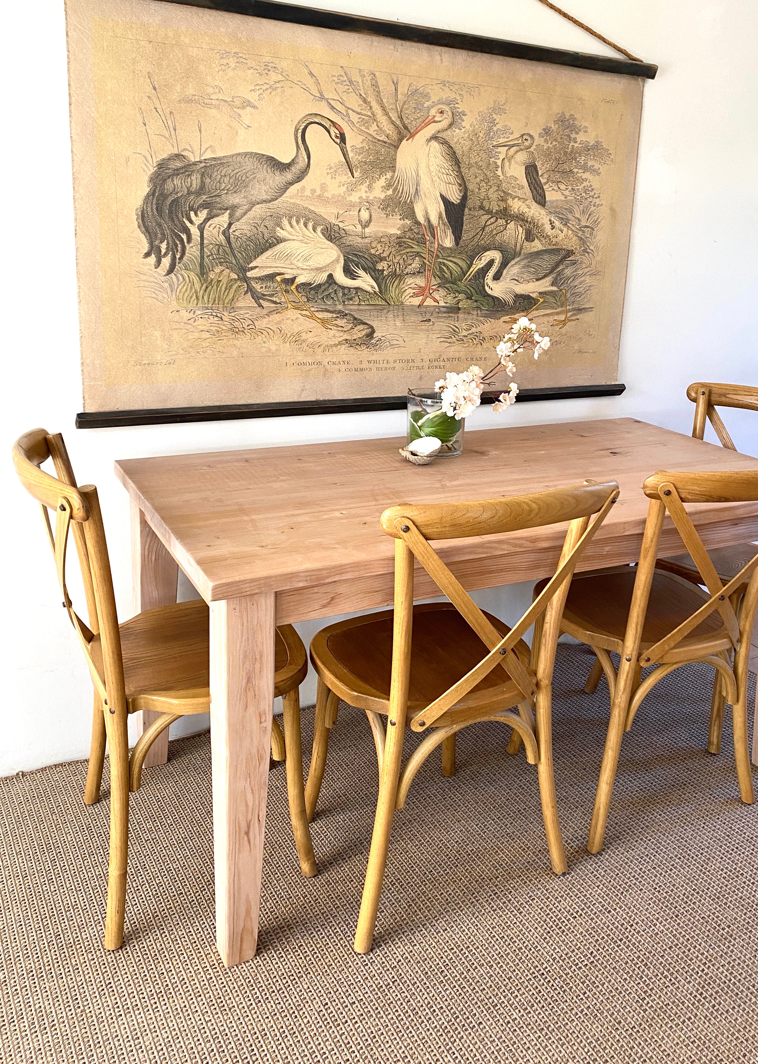 A provincial farmhouse style wooden table with tapered legs, accompanied by matching chairs. Solid wood
