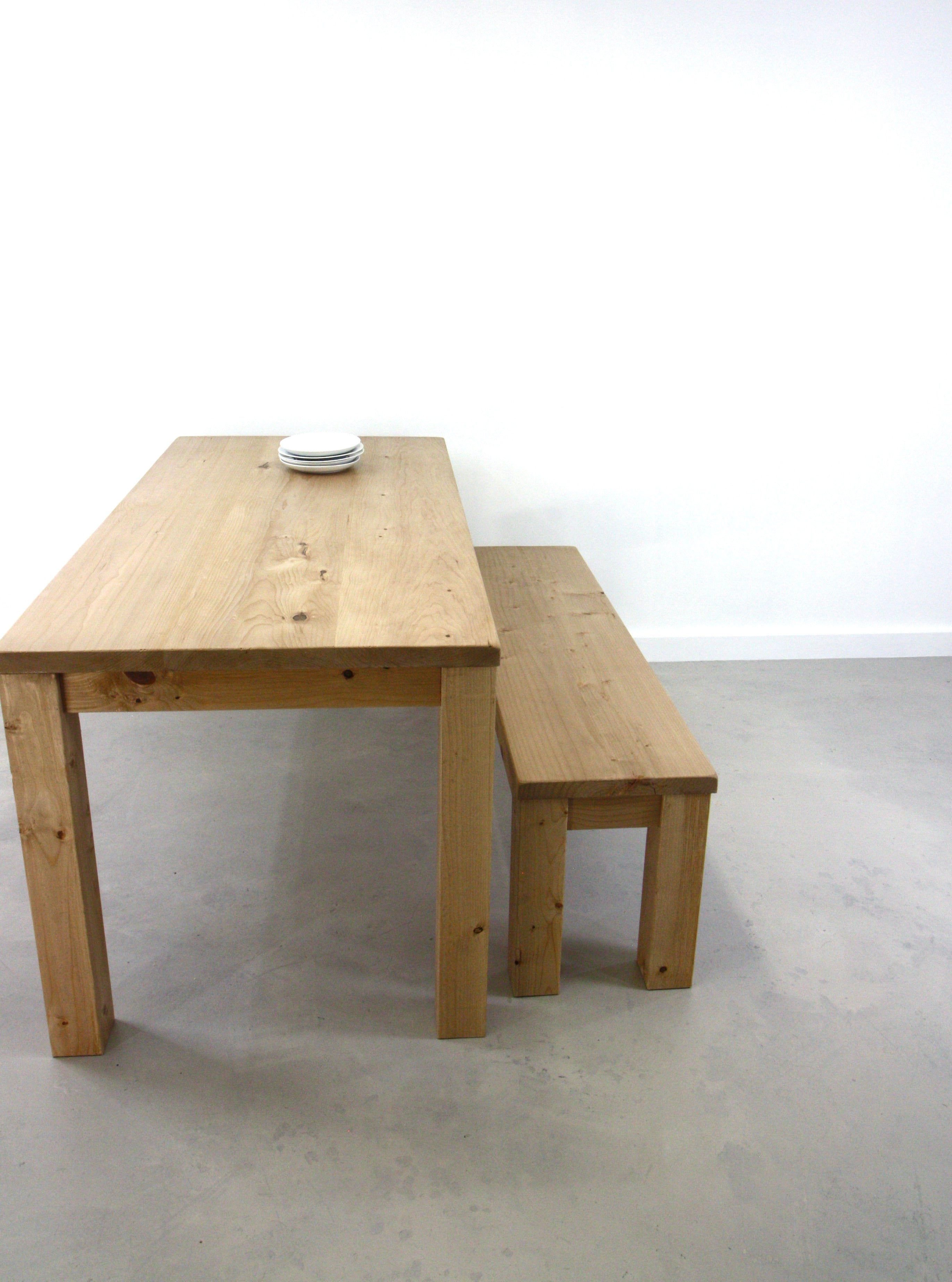A Parsons Farmhouse kitchen/dining table with a matching bench made of reclaimed wood