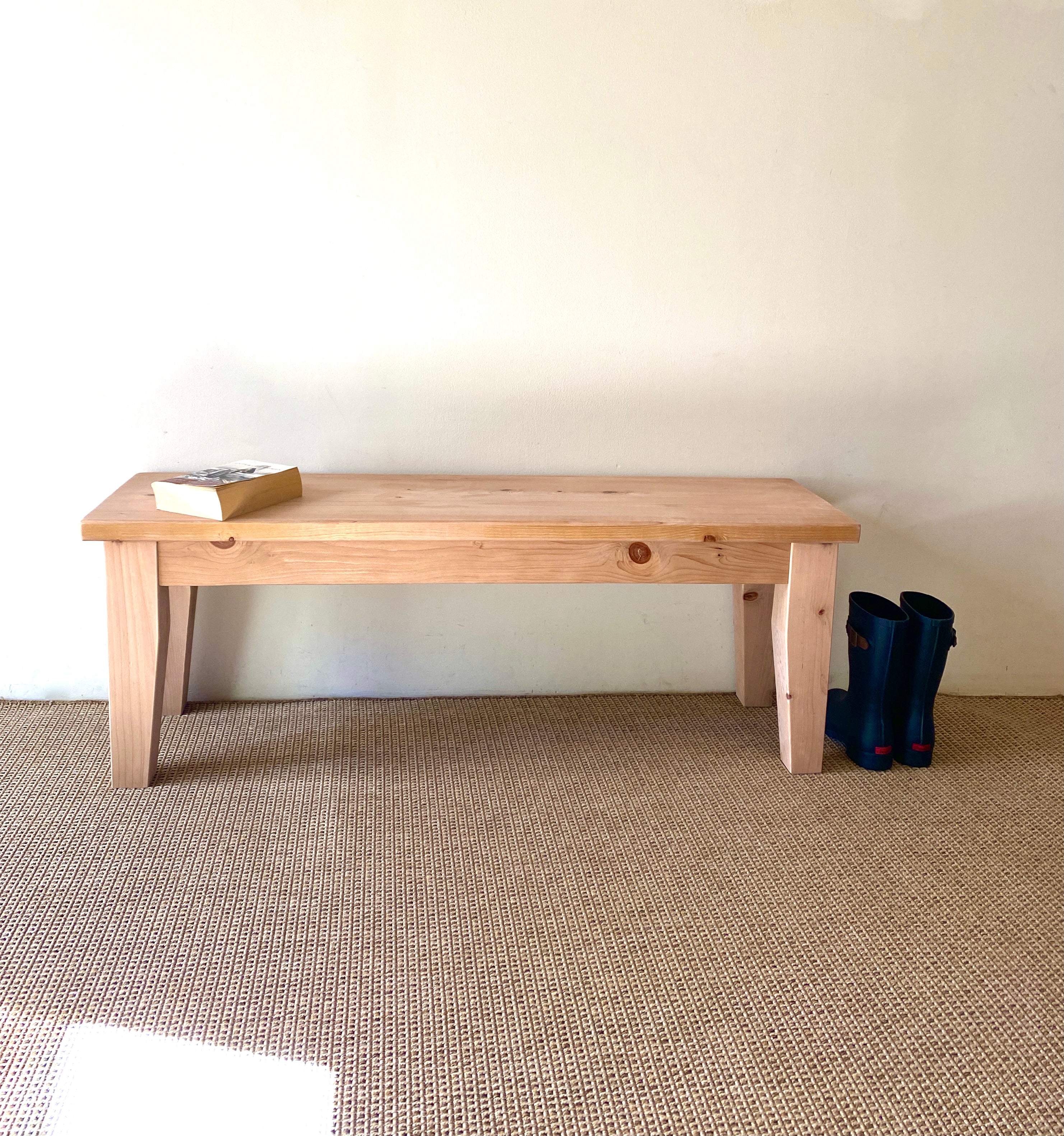 A Provincial Wood Bench made of reclaimed wood, displayed in a room setting 